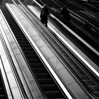 People in geometry of light and shadow at train stations