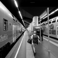 People in geometry of light and shadow at train stations
