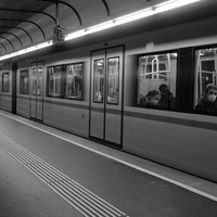 People in geometry of light and shadow at train stations