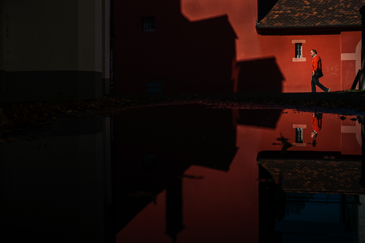 man walking, wearing a red jumper 