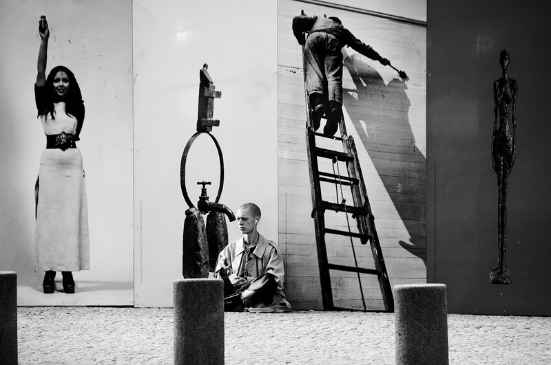 Man in front of billboards