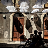 Umbrellas, light and the people on the bike