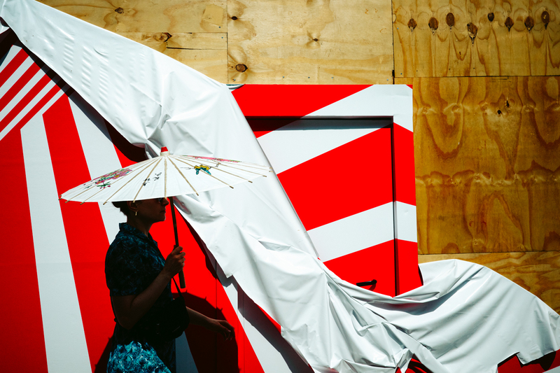 Woman With Umbrella Walking By A Metropolitan Canvas