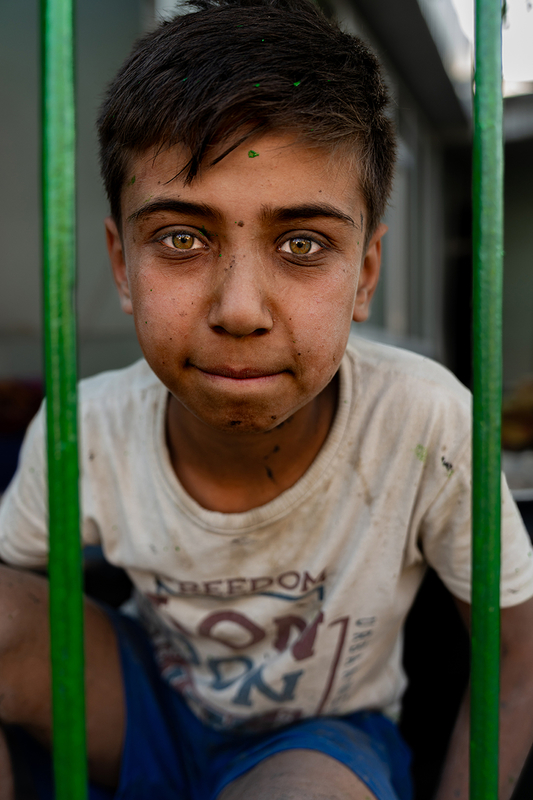 Tajik Boy Painting a Fence 